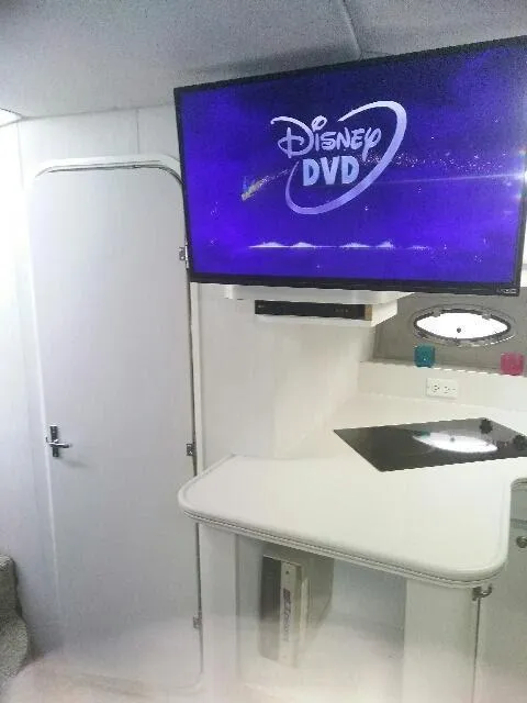 Slide: The Image of 1994 Cruisers Yachts 3672 Express docked at marina, overcast sky, calm water reflections. - 17