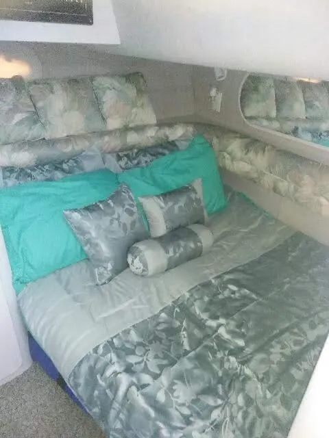 Slide: The Image of 1994 Cruisers Yachts 3672 Express boat interior with white seating and carpeted floor. - 18