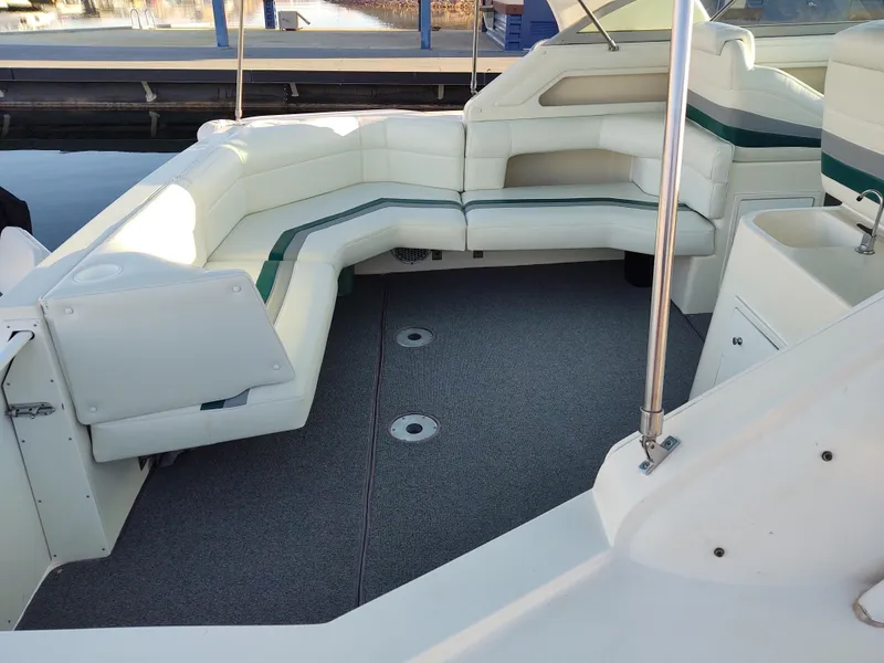 Slide: The Image of 1994 Cruisers Yachts 3675 Esprit with swimmer in water, featuring deck chairs and ladder. - 20