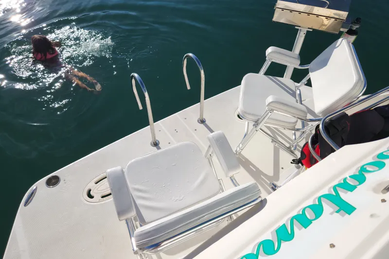 Slide: The Image of Girl enjoying sun on 1994 Cruisers Yachts 3675 Esprit, with scenic water backdrop. - 22