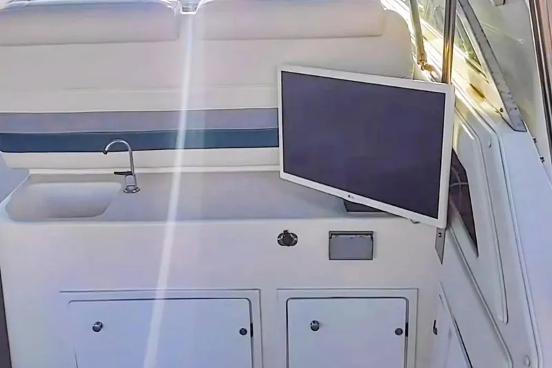 Slide: The Image of 1994 Cruisers Yachts 3675 Esprit with blue LED lights at night, docked with passengers. - 25