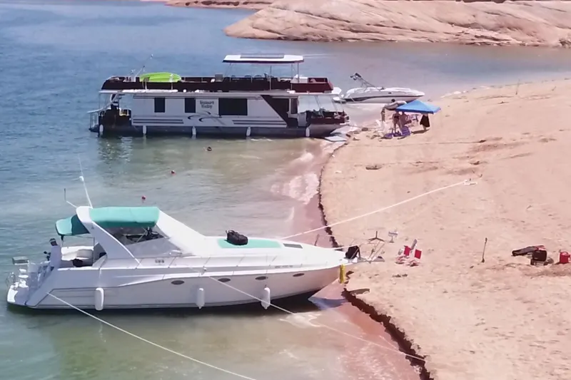 Slide: The Image of 1994 Cruisers Yachts 3675 Esprit on calm water, featuring sleek design and turquoise accents. - 29