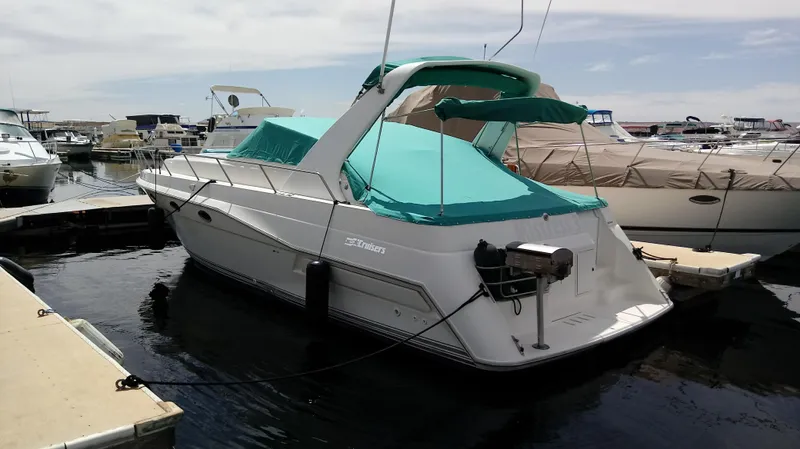 Slide: The Image of 1994 Cruisers Yachts 3672 Express with chairs on deck, docked at marina. - 5