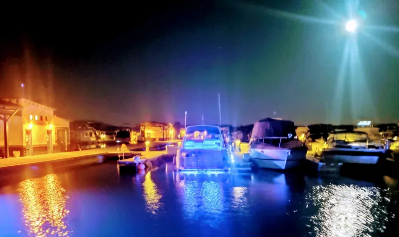 Slide: The Image of 1994 Cruisers Yachts 3672 Express cabin with plaid bedding and overhead skylight. - 8