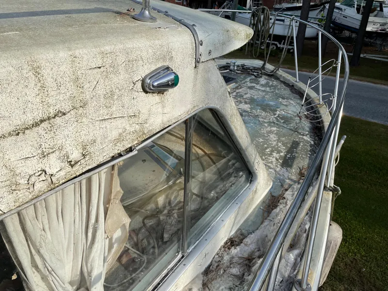 Slide: The Image of 1964 Hatteras Double Cabin boat in need of restoration, showing weathered exterior. - 6