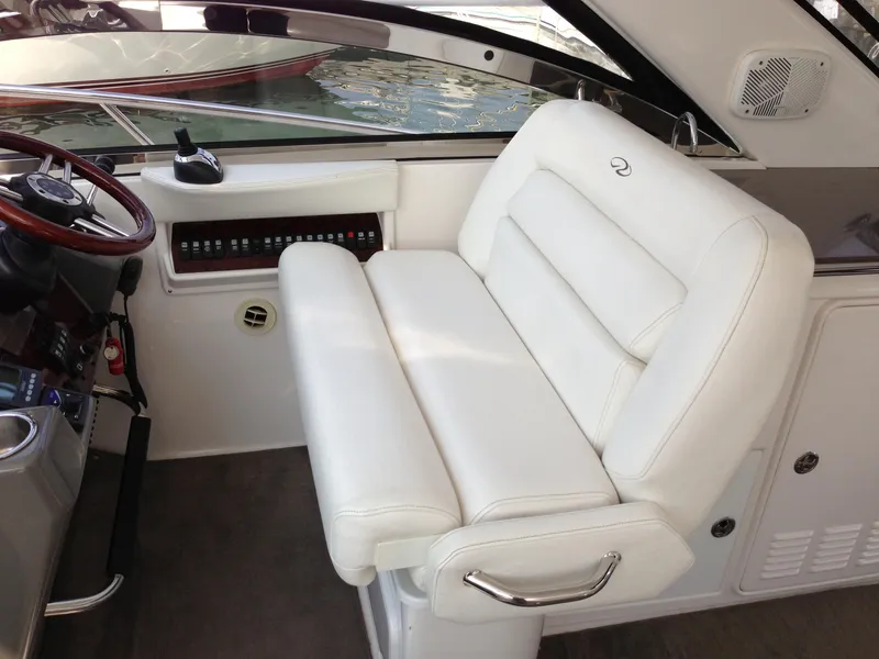 Slide: The Image of 2008 Regal Commodore 4460 boat interior with white leather seating and control panel. - 16