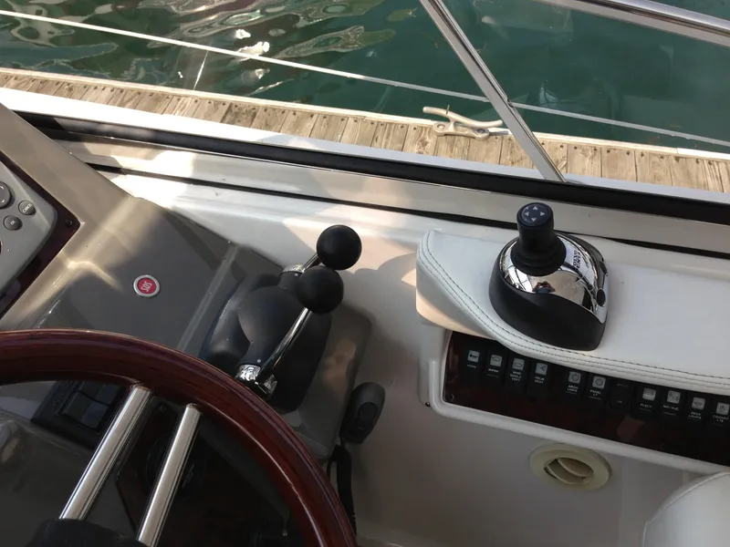 Slide: The Image of 2008 Regal Commodore 4460 helm with controls and steering wheel, dockside view. - 19