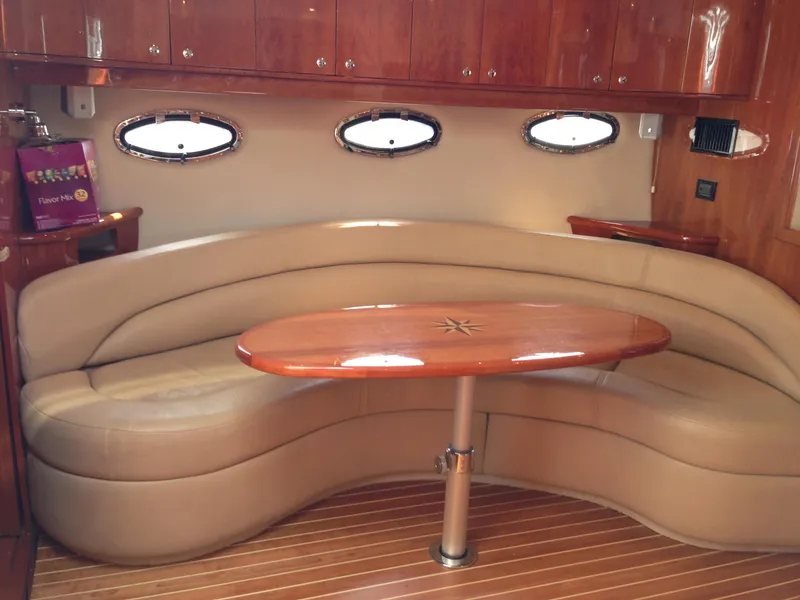 Slide: The Image of Luxurious interior of 2008 Regal Commodore 4460 yacht with leather seating and wooden table. - 21