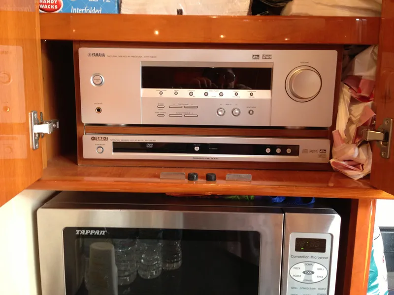 Slide: The Image of Audio and video equipment in a wooden cabinet on a 2008 Regal Commodore 4460 yacht. - 24