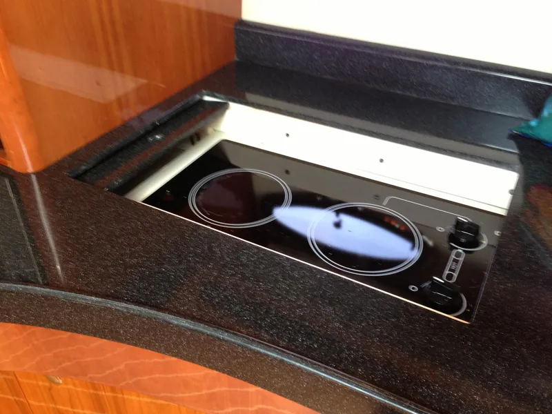 Slide: The Image of Built-in stovetop on 2008 Regal Commodore 4460 yacht kitchen counter. - 25
