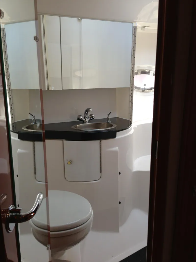 Slide: The Image of 2008 Regal Commodore 4460 yacht bathroom with dual sinks and modern fixtures. - 30