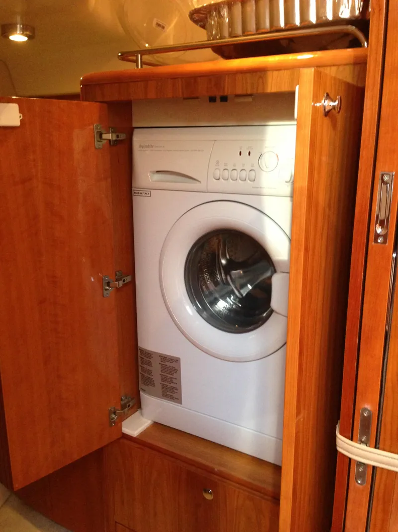 Slide: The Image of Washing machine inside 2008 Regal Commodore 4460 yacht's wooden cabinet. - 35