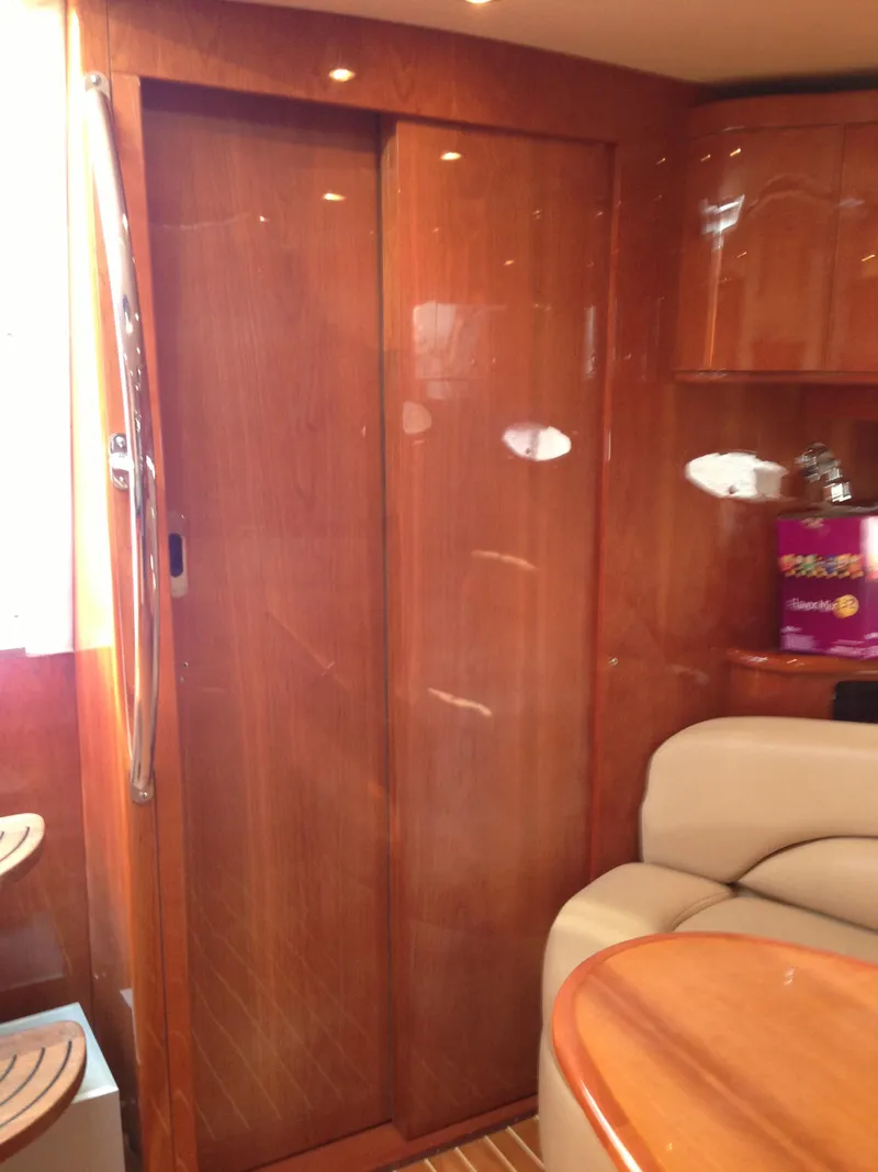 Slide: The Image of 2008 Regal Commodore 4460 yacht interior with polished wood finish and comfortable seating. - 41