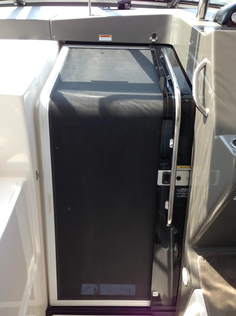 Slide: The Image of 2008 Regal Commodore 4460 boat interior with sleek black door and chrome handle. - 42