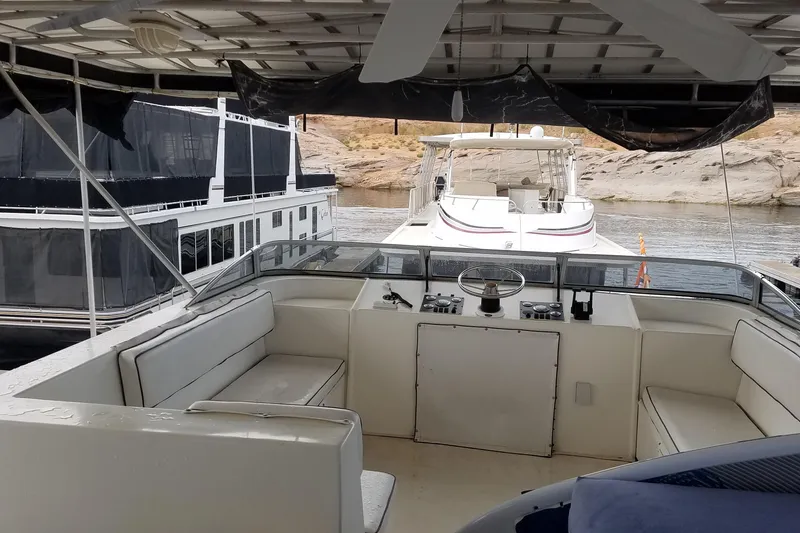 Slide: The Image of Cockpit view of 2000 Navigator Showboat yacht docked near rocky shoreline. - 10