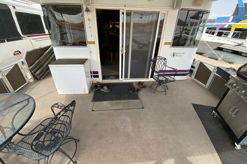 Slide: The Image of Outdoor deck of a 2000 Navigator Showboat with chairs and a table. - 2