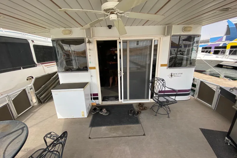 Slide: The Image of Outdoor deck of a 2000 Navigator Showboat with seating and ceiling fan. - 3
