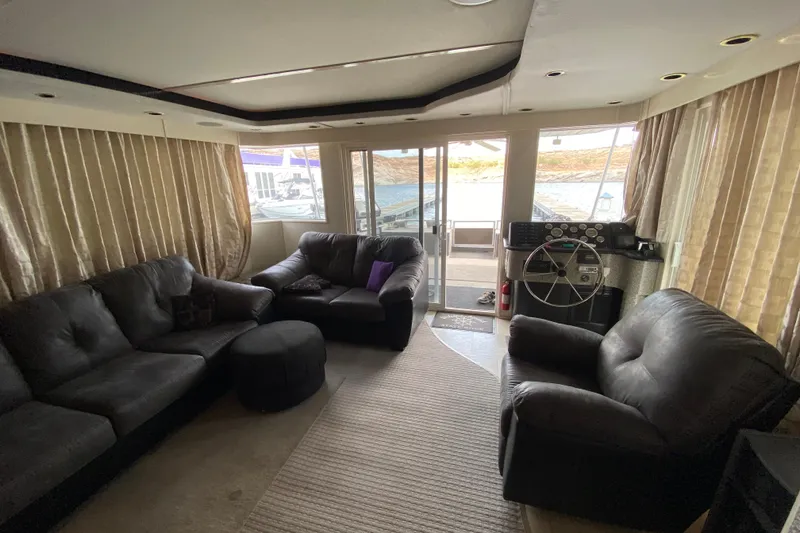 Slide: The Image of Luxurious 2000 Navigator Showboat interior with leather seating and helm, overlooking marina. - 6