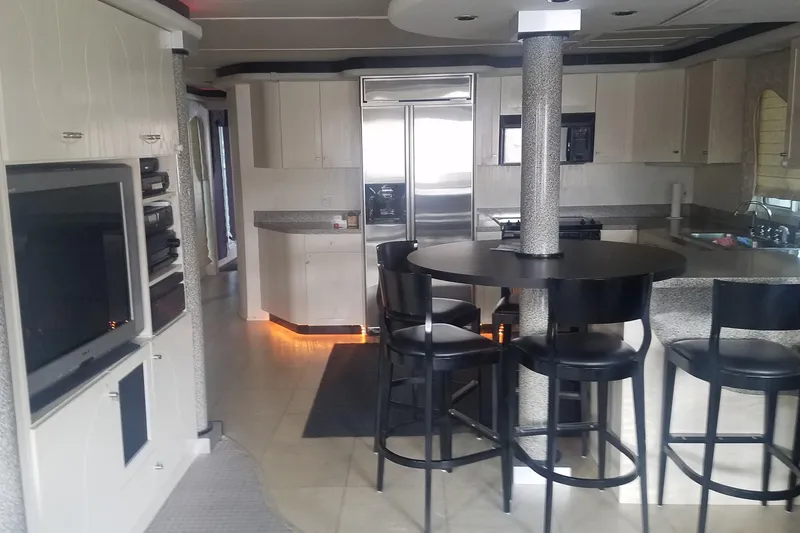 Slide: The Image of Luxurious 2000 Navigator Showboat kitchen with modern appliances and sleek black seating. - 8