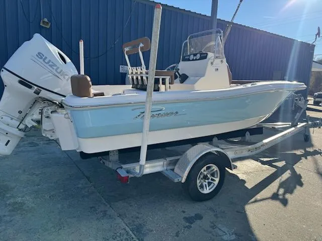 The Image of 2025 Pioneer 180 Islander boat on trailer with Suzuki outboard motor. - 1