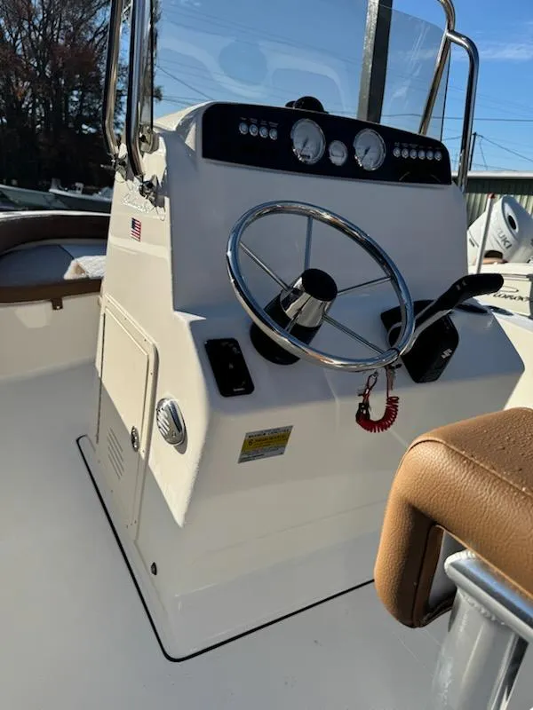 Slide: The Image of 2025 Pioneer 180 Islander boat console with steering wheel and gauges. - 3