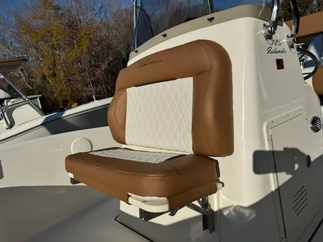 Slide: The Image of 2025 Pioneer 180 Islander boat seat with brown and white upholstery. - 5