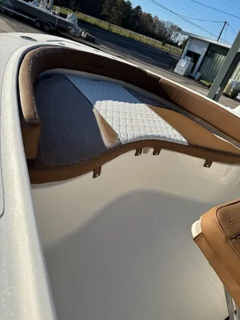 Slide: The Image of 2025 Pioneer 180 Islander boat interior with brown and white seating. - 6