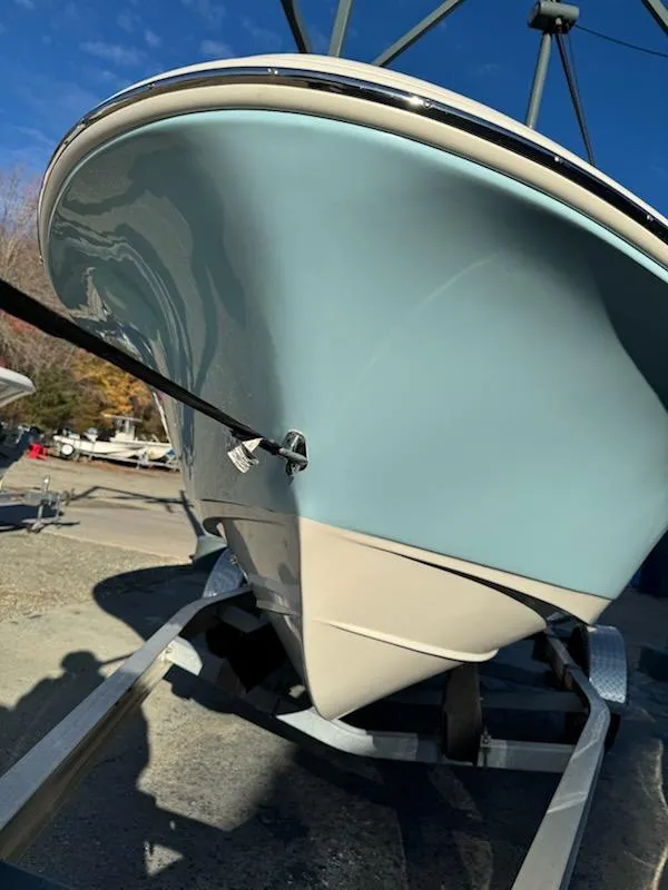 Slide: The Image of 2025 Pioneer 180 Islander boat on trailer, blue hull, sunny day. - 7