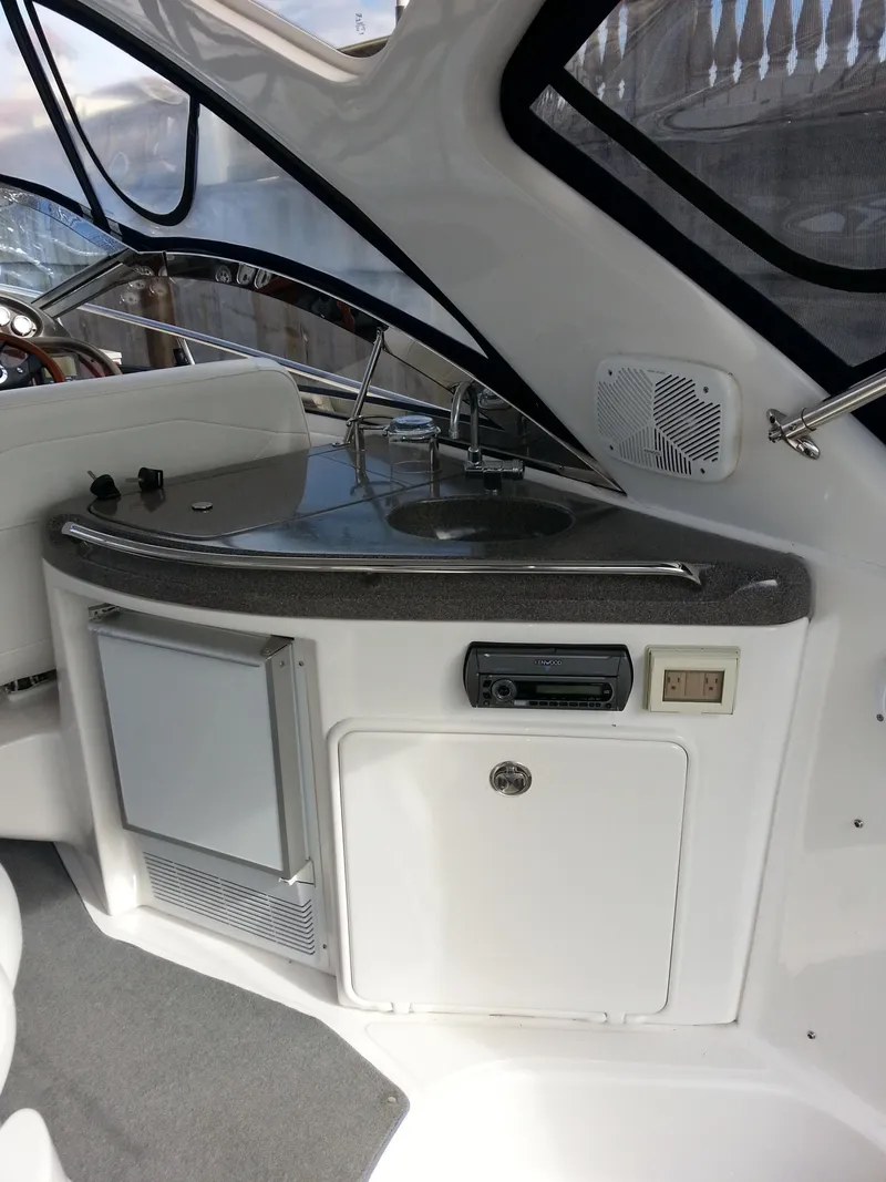 Slide: The Image of 2007 Regal Commodore 4060 yacht interior with kitchenette and modern amenities. - 15