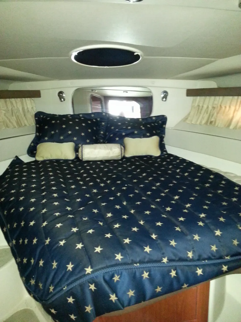 Slide: The Image of Luxurious cabin interior of 2007 Regal Commodore 4060 yacht with star-patterned bedding. - 22
