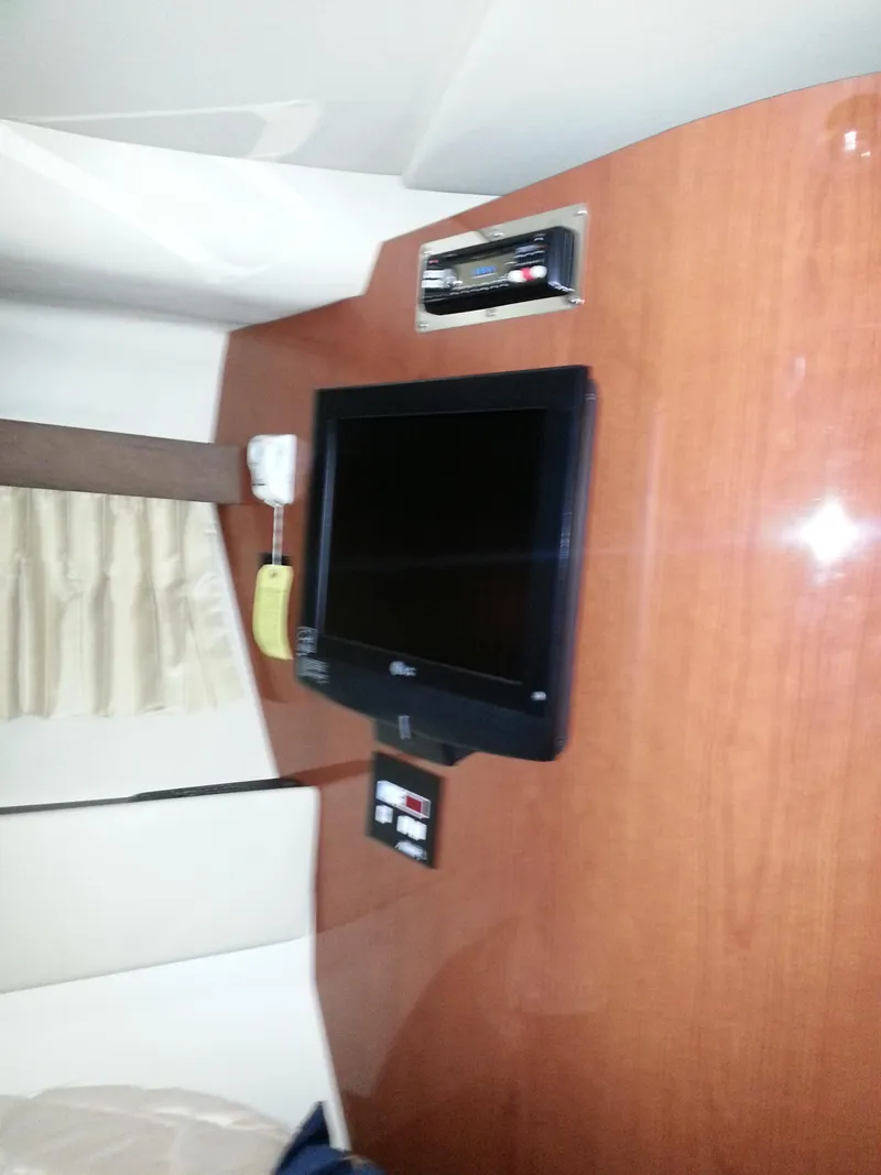 Slide: The Image of 2007 Regal Commodore 4060 interior with mounted TV and control panel. - 23