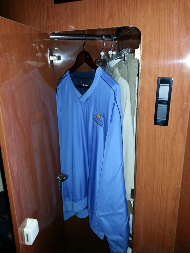 Slide: The Image of Wooden closet in 2007 Regal Commodore 4060 yacht with blue jacket and beige pants. - 24