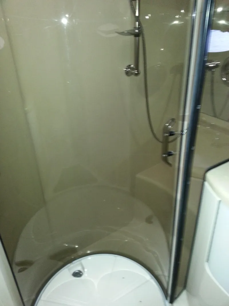 Slide: The Image of Shower area in 2007 Regal Commodore 4060 yacht, featuring glass door and modern fixtures. - 26