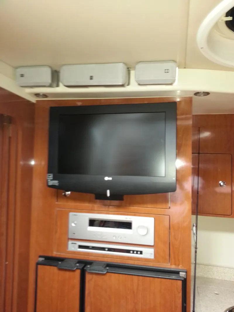 Slide: The Image of 2007 Regal Commodore 4060 interior with TV, sound system, and wooden cabinetry. - 29