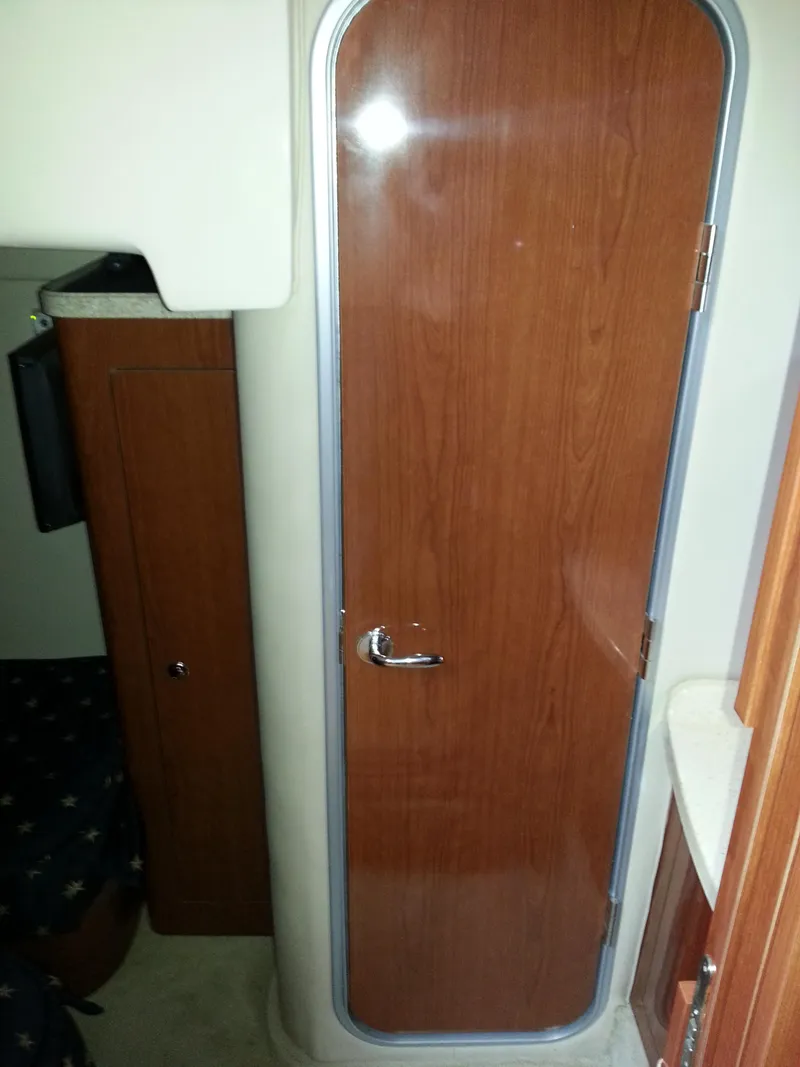 Slide: The Image of 2007 Regal Commodore 4060 cabin interior with wooden door and compact design. - 31