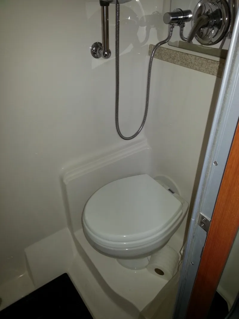 Slide: The Image of 2007 Regal Commodore 4060 boat bathroom with toilet and showerhead. - 34