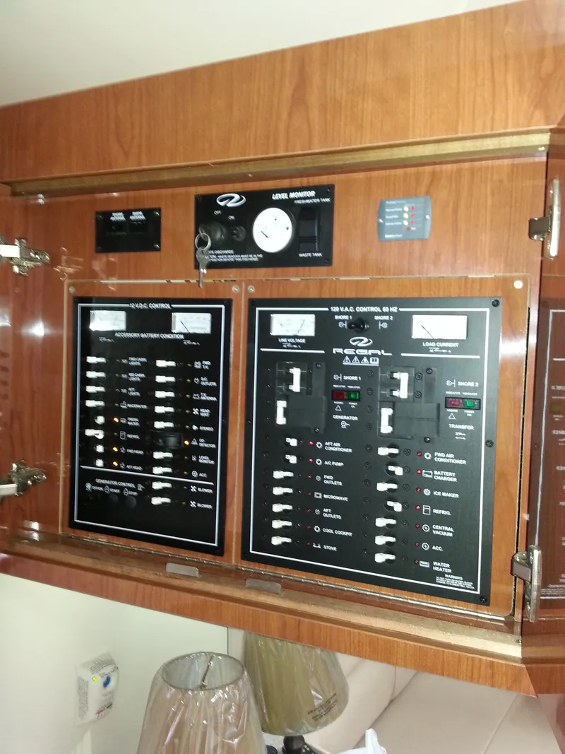 Slide: The Image of Control panel of a 2007 Regal Commodore 4060 yacht, featuring various switches and gauges. - 36