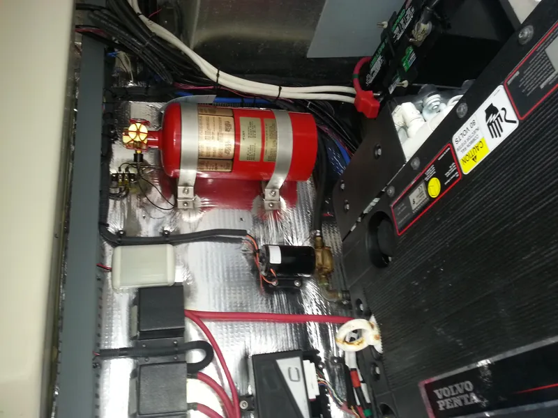 Slide: The Image of Engine compartment of 2007 Regal Commodore 4060 with fire extinguisher and wiring. - 8