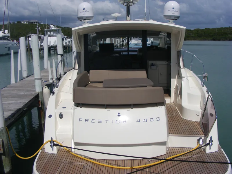 Slide: The Image of Luxury 2012 Prestige 440S yacht docked at marina, featuring spacious deck and modern design. - 13