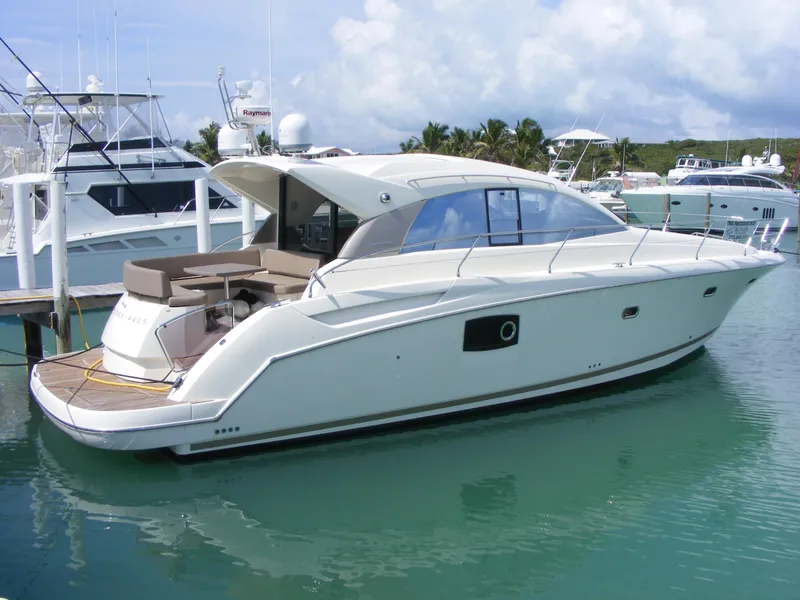Slide: The Image of 2012 Prestige 440S yacht docked in a marina with clear blue water. - 14