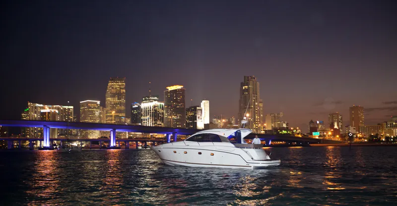 Slide: The Image of Luxury yacht Prestige 440S, 2012 model, cruising at night with city skyline backdrop. - 24