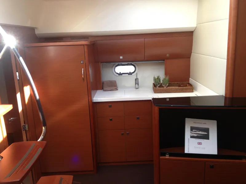 Slide: The Image of Luxurious interior of 2012 Prestige 440S yacht with wooden cabinetry and modern amenities. - 26