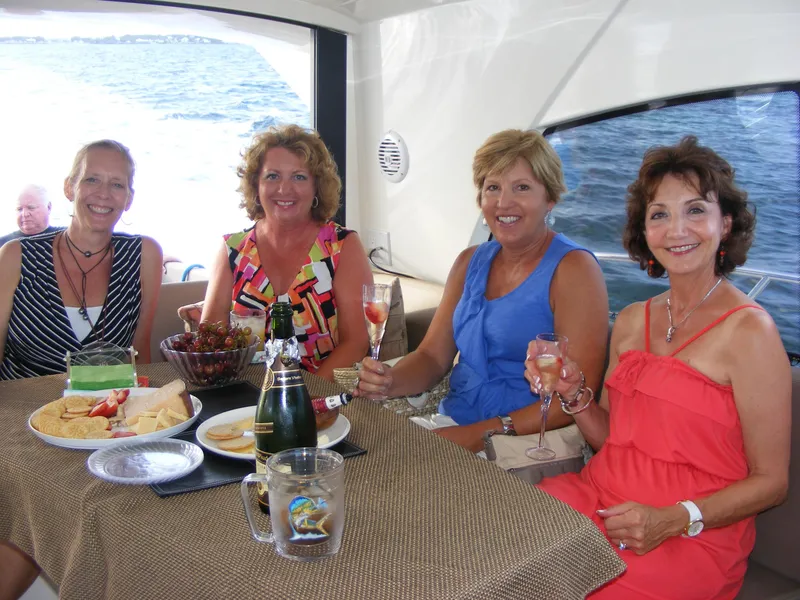 Slide: The Image of Women enjoying drinks and snacks on a 2012 Prestige 440S yacht. - 27