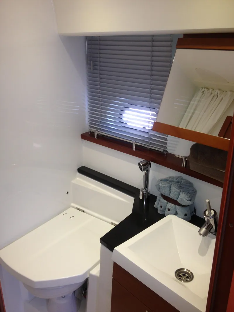Slide: The Image of Compact bathroom in 2012 Prestige 440S yacht with modern fixtures and window blinds. - 32