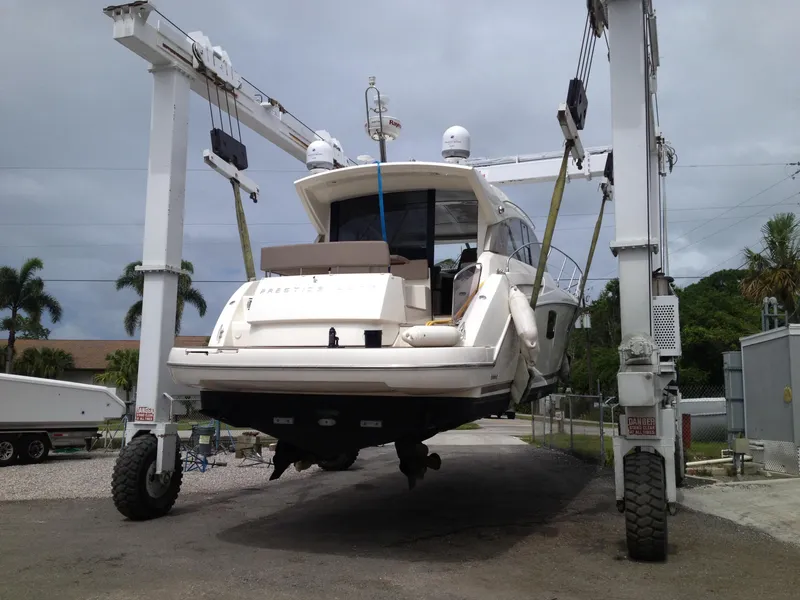Slide: The Image of 2012 Prestige 440S yacht lifted by crane in a marina setting. - 43