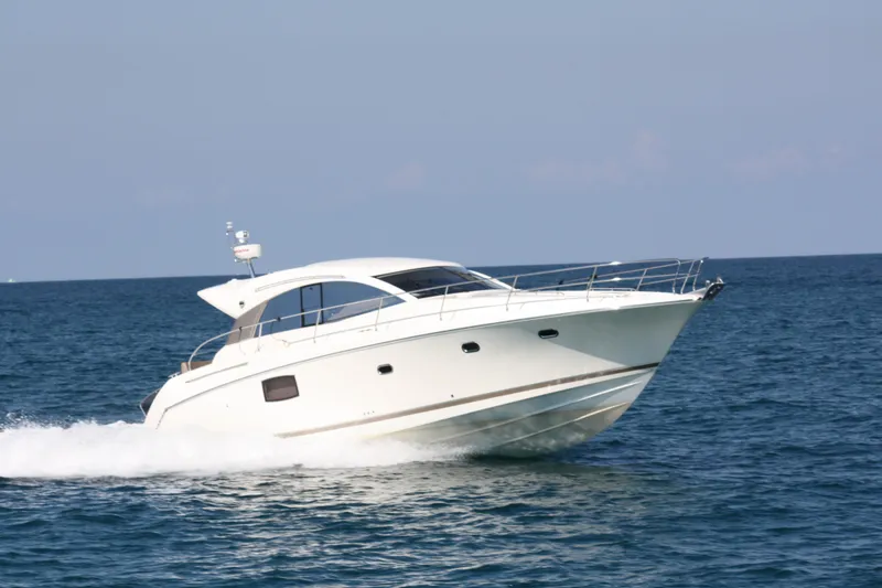 Slide: The Image of Luxury 2012 Prestige 440S yacht cruising on open water. - 6