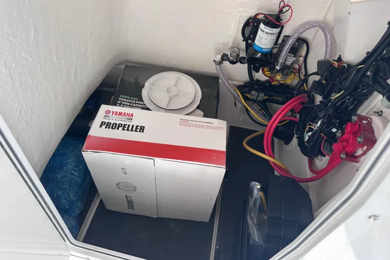 Slide: The Image of Storage compartment of 2026 Edgewater 188CC with Yamaha propeller box and wiring. - 10