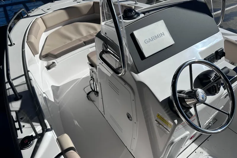 Slide: The Image of 2026 Edgewater 188CC boat interior with Garmin navigation and cushioned seating. - 11