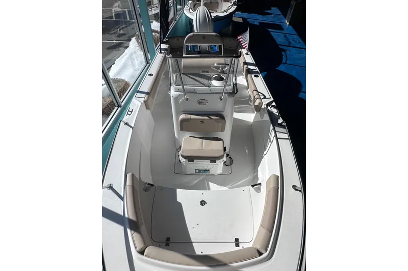 Slide: The Image of 2026 Edgewater 188CC boat interior with seating and console, displayed indoors. - 17