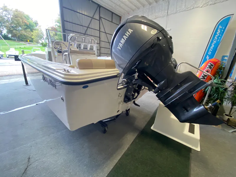 Slide: The Image of Open storage compartment on 2026 Edgewater 188CC boat, featuring a built-in cooler. - 7